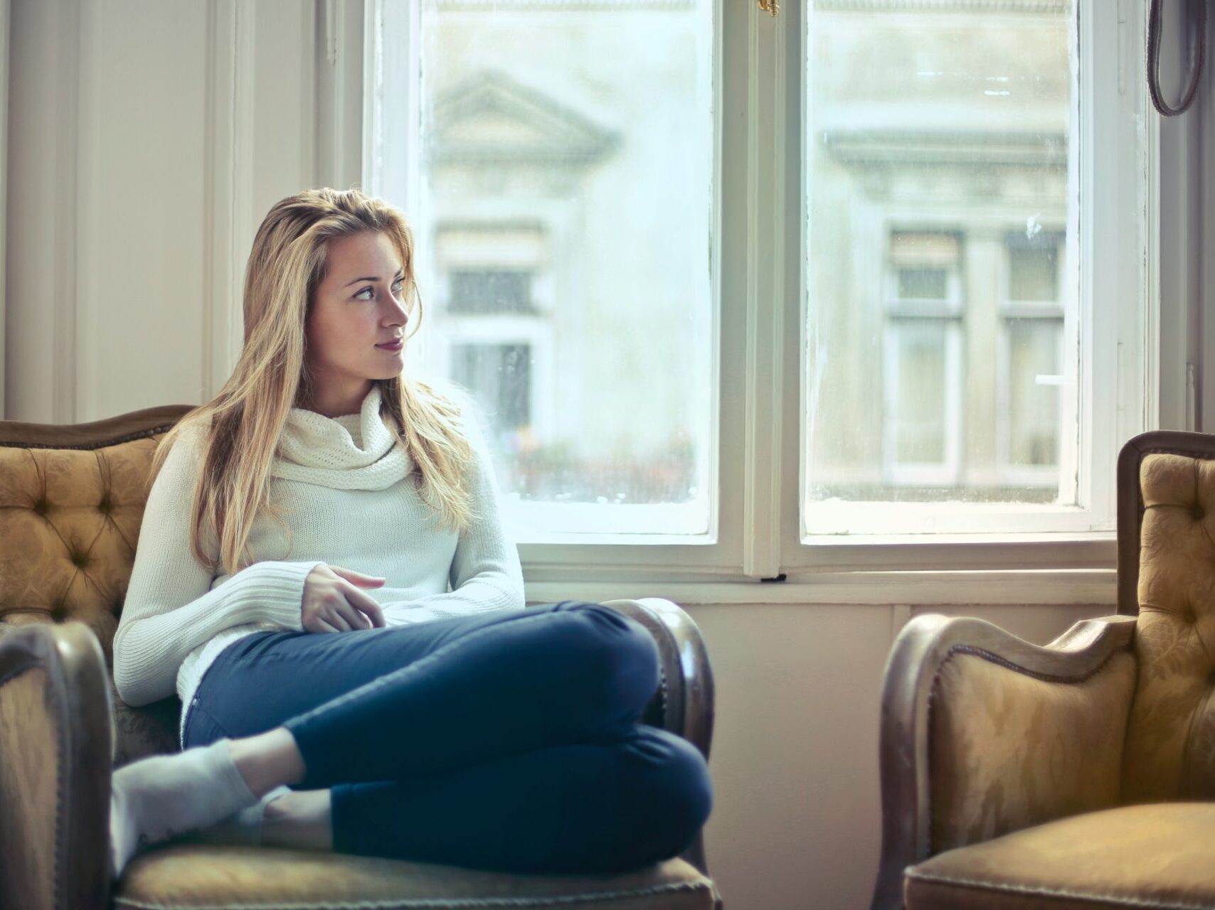 woman sitting on couch enjoying her HVAC services