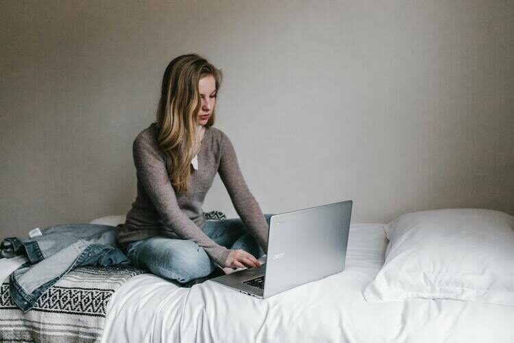 woman working on bed