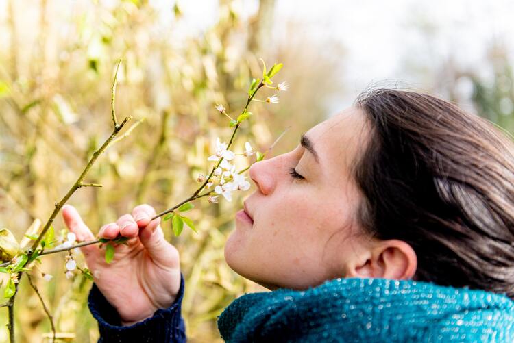 woman smelling flowers