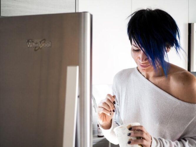 woman eating ice cream from fridge