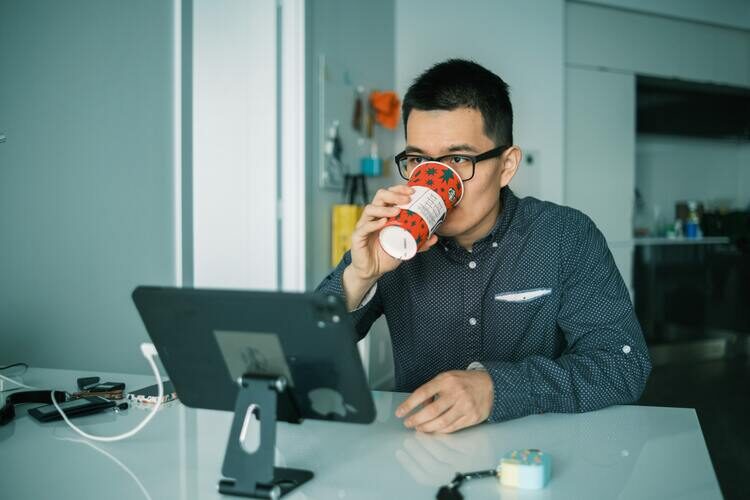 man drinking coffee at office